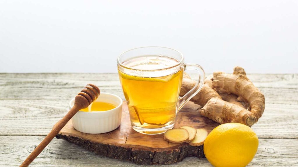 Blog title-Liver Detox Tea: Your Complete Guide. Image is of a glass mug of tea with ginger, lemon and honey around it.